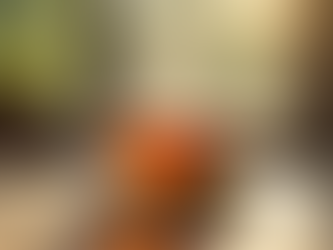 Cup of tea steaming on a table near a window