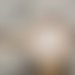 A cozy cup of coffee with heart-shaped latte art rests on a soft, knit blanket, surrounded by twinkling fairy lights, creating a warm and inviting atmosphere.