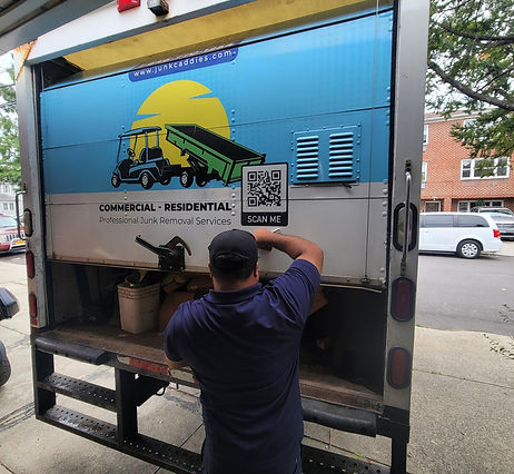 One of our crew members closing the back of our junk removal truck
