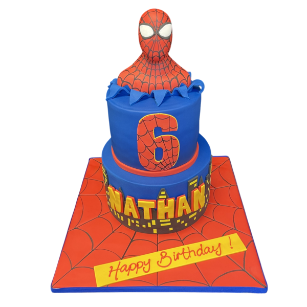 Comic book themed Spiderman cake with intricate icing detailing, perfect for superhero fans. Brightly coloured with the iconic Spiderman logo on top. Ideal for birthday parties and special occasions.