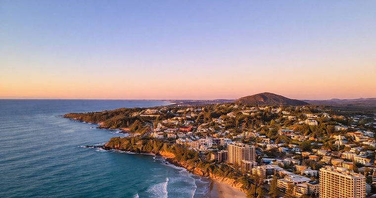 Scenic aerial view of the Sunshine Coast coastline, a key region where JT Industries & Co transforms residential and commercial properties with expert cement rendering and bespoke architectural finishes.