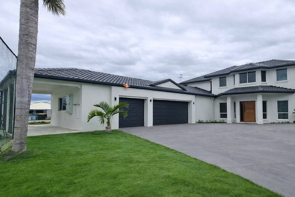 Front exterior of a sprawling two-story residential home in Redcliffe featuring a complete facade modernization with crisp white exterior painting and smooth rendering by JT Industries & Co.