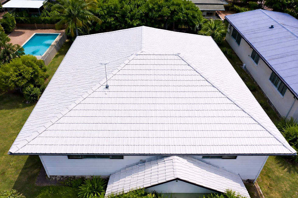 Flawlessly repainted white tile roof on a suburban home, showcasing the dramatic visual transformation and enhanced exterior protection provided by expert roof restoration services.