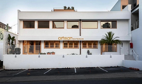 Artisan Exterior Featuring Tyrolean facade with timber stained windows and white colour stucco. located in Brisbane city