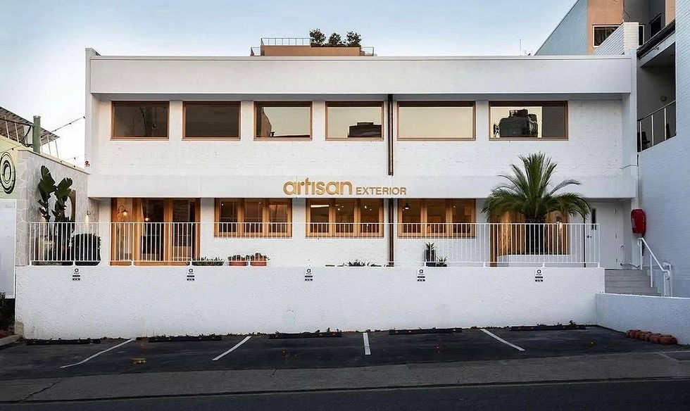 Front facade of the Artisan Exterior commercial building featuring a crisp white protective paint finish over brickwork and a seamlessly rendered front boundary wall by JT Industries & Co.