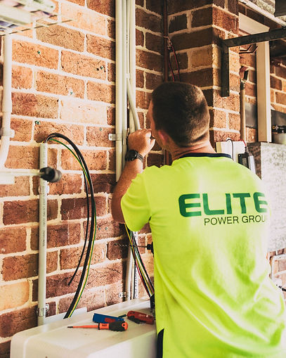 An electrician working on conduit for a residential house.
