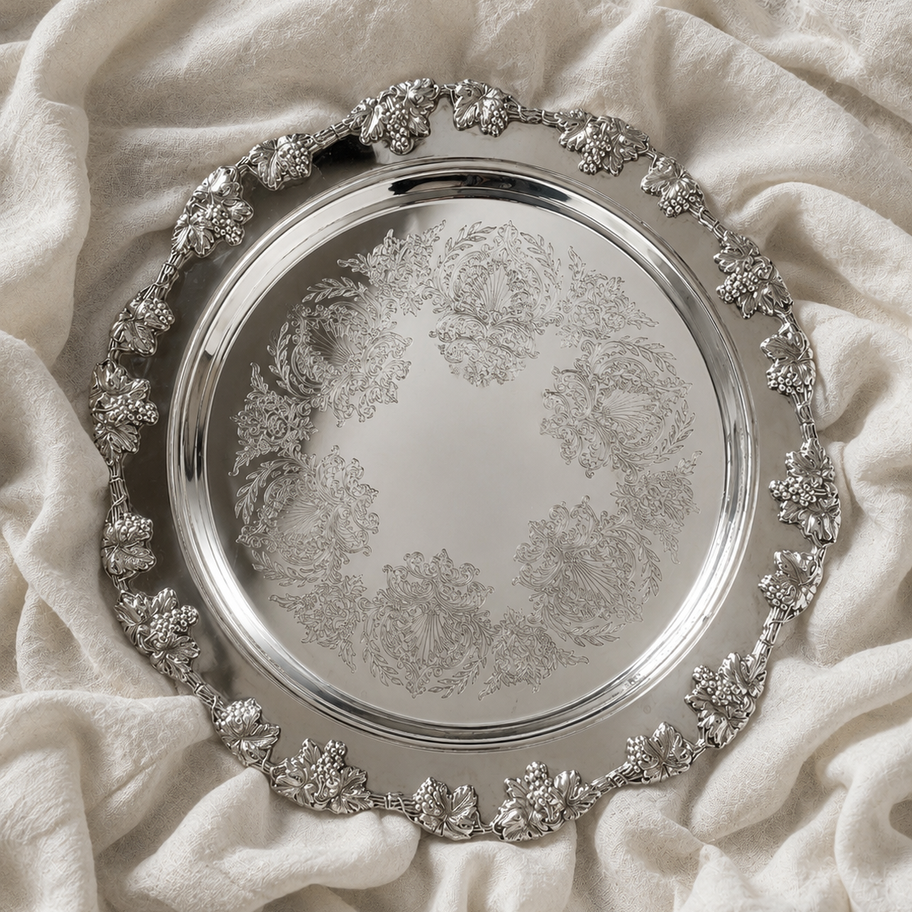 Vintage round silver serving tray with grape vine border and engraved centre for elegant wedding and event styling.