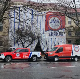 JMS trucks in front of a historic restoration masonry job