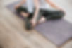 Woman seated in yoga pose on mat — join East West Yoga online community Singapore
