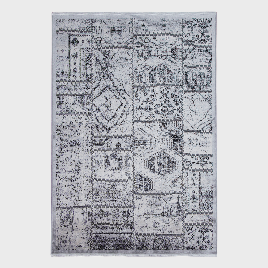 Gray and white patterned area rug with a distressed finish