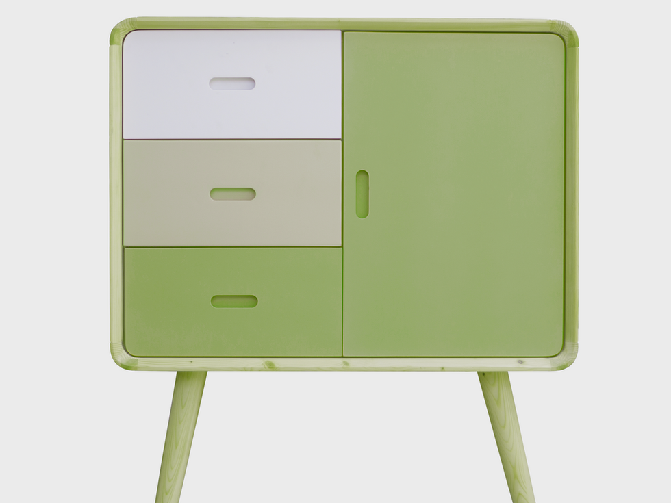 Sage green dresser with three drawers and a door