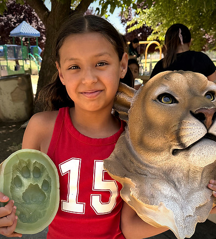 girl-with-mountain-lion-model-paw-cast-summer-science-project