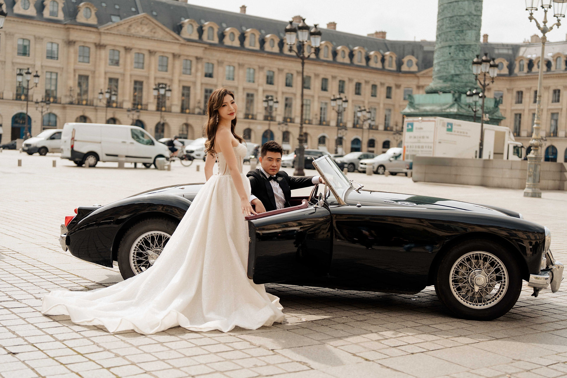 Couple driving vintage car at Place Vendôme