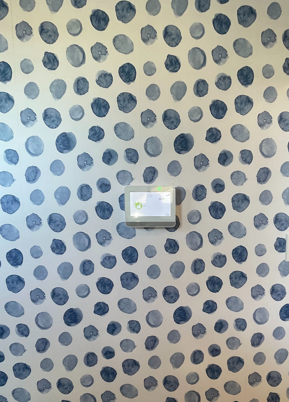 Close-up view of a smart home security control panel on a wall