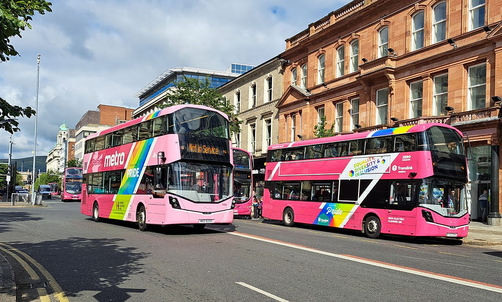A pair of buses in Pride colours.