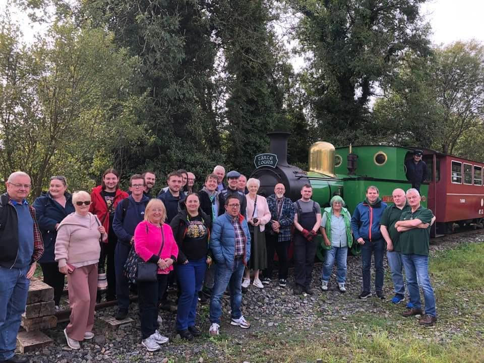 Tour group beside steam train