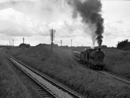 Loco 638 brings a train of hoppers off the Kingscourt branch at Navan, Photo: Ernie's Railway Archive.