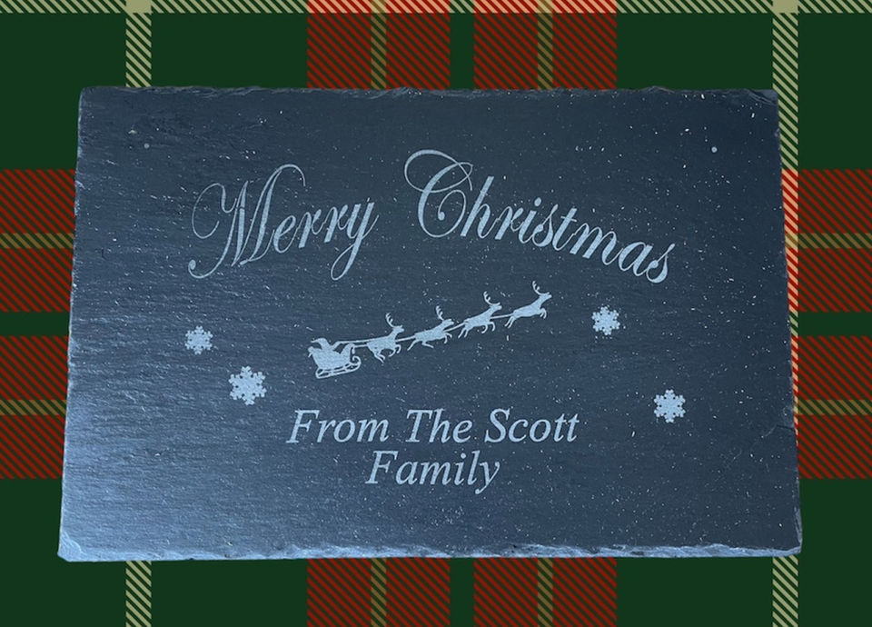 A slate sign engraved by Sweet Pea Laser boutique which reads "Merry Christmas from the scott family"
