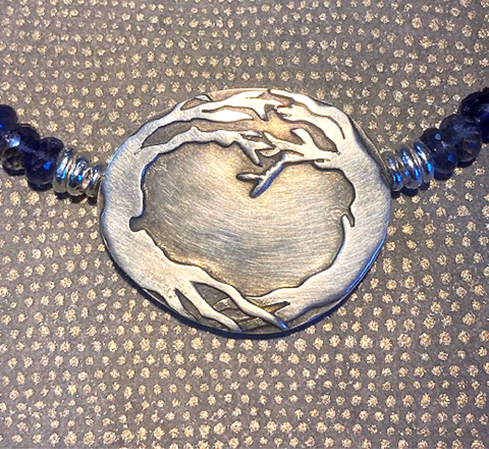 Embracing trees necklace.