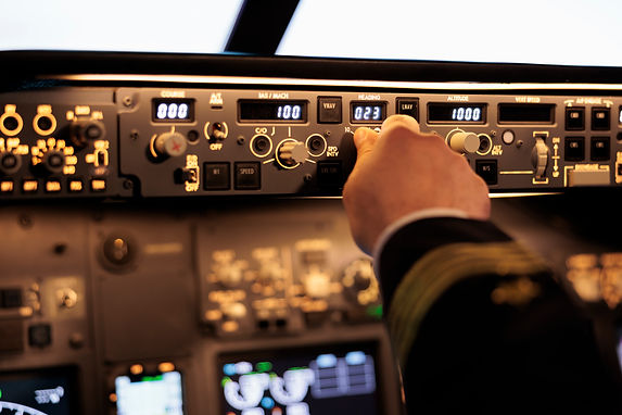male-captain-fixing-altitude-longitude-level-dashboard-plane-cockpit-pilot-pushing-buttons
