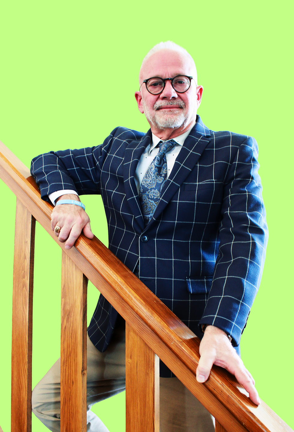 David, the founder of The Happy Molar, on a staircase railing