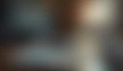 computer and journal with a pen on a desk