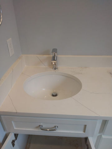 Quartz countertop with integrated bathroom sink and modern faucet in Brunswick, GA remodel