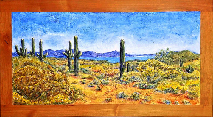 Saguaro sculpted landscape bas-relief in blue, sage, ochre, and terracotta on reclaimed cabinet door by Alyson Miller
