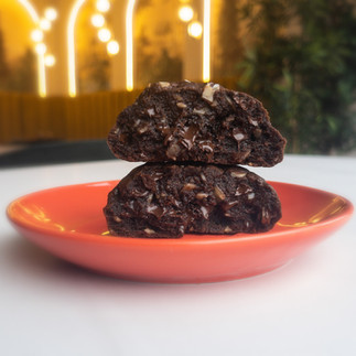 a chocolate chip cookies cut open and served on a red plate 