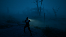 Man with a flashlight in the darkness