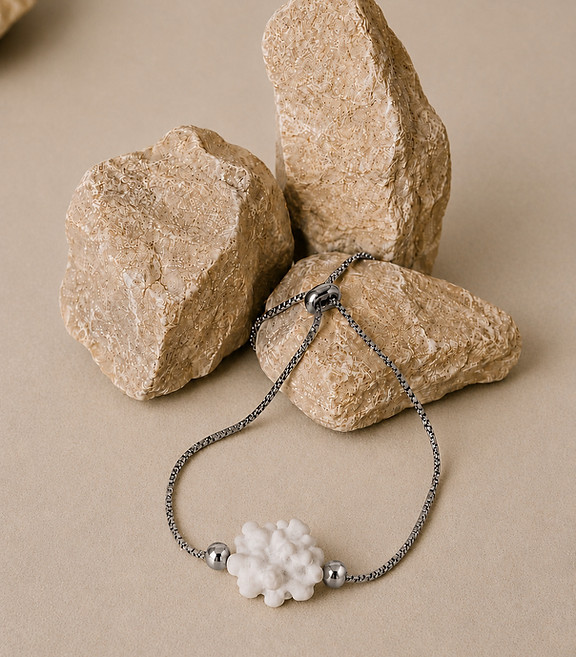White coral inspired bracelet displayed with natural stones