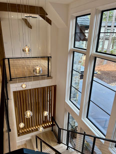 The Rings Staircase Chandelier is a sculptural cascade of hand‑blown glass pendants, designed to accentuate the vertical beauty of multi‑story spaces. Each glass ring is individually crafted, creating a floating, luminous composition that descends gracefully through the stairwell. The staggered arrangement highlights the chandelier’s modern elegance, while the warm glow of the glass adds depth, movement, and architectural drama. Perfect for luxury homes with tall ceilings, open staircases, and contemporary interiors seeking a statement lighting piece with artisanal character.