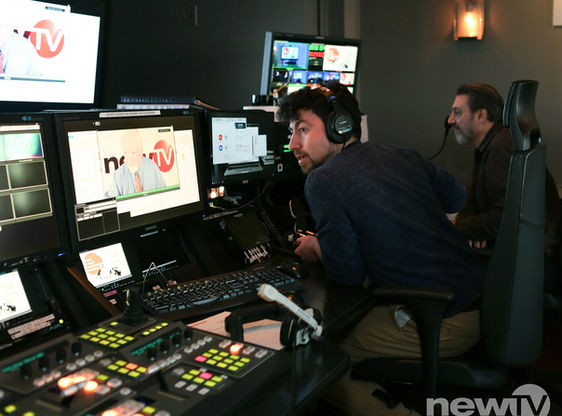 Two men in the control room of a television studio.