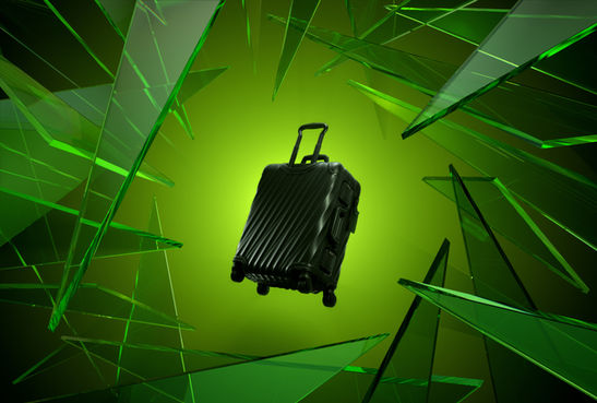 CGI of TUMI suitcase amid shattered green glass for promo