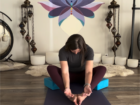 a woman in butterfly pose on a yoga mat