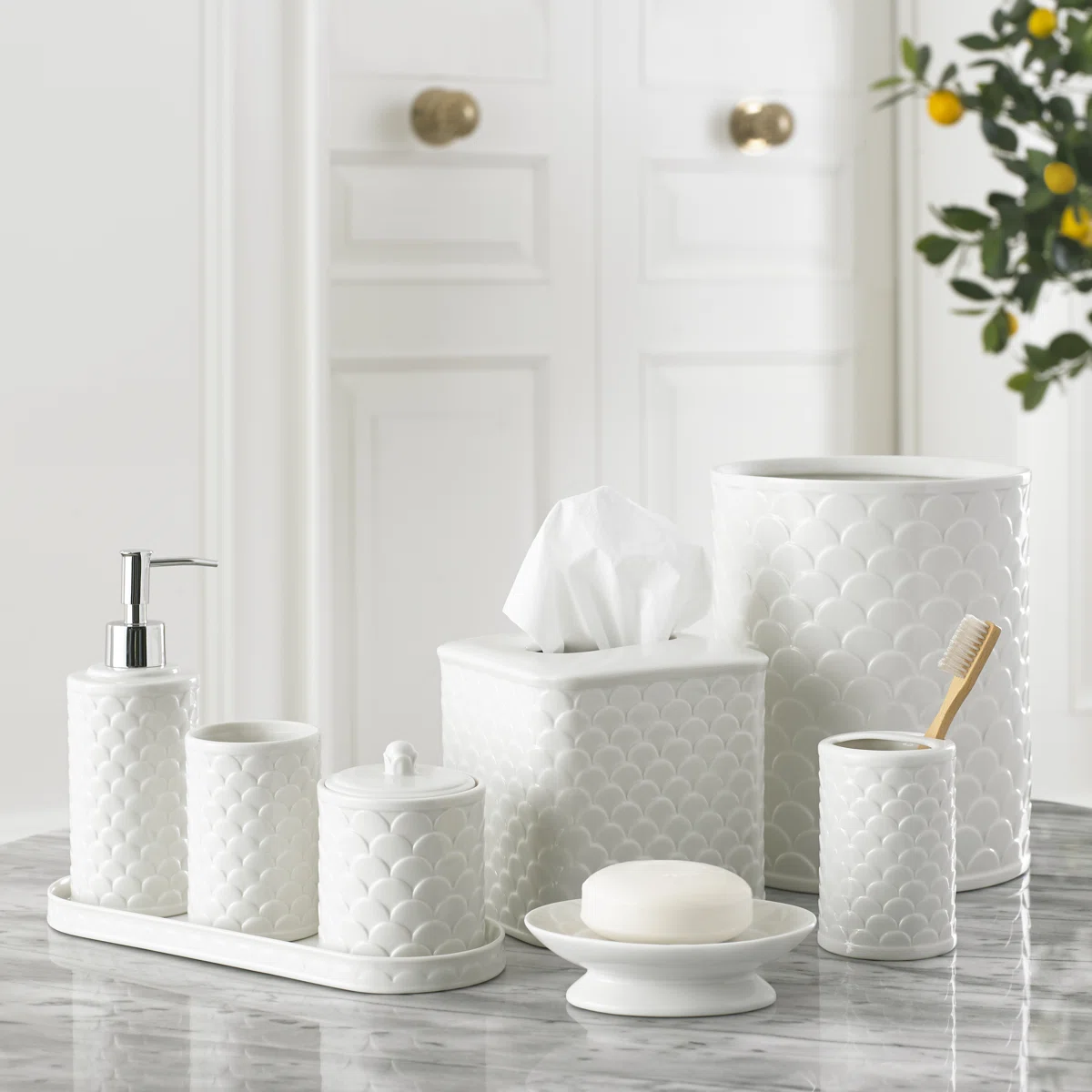 Neutral bathroom decor accessories with candles, ceramic pieces and soft luxury styling