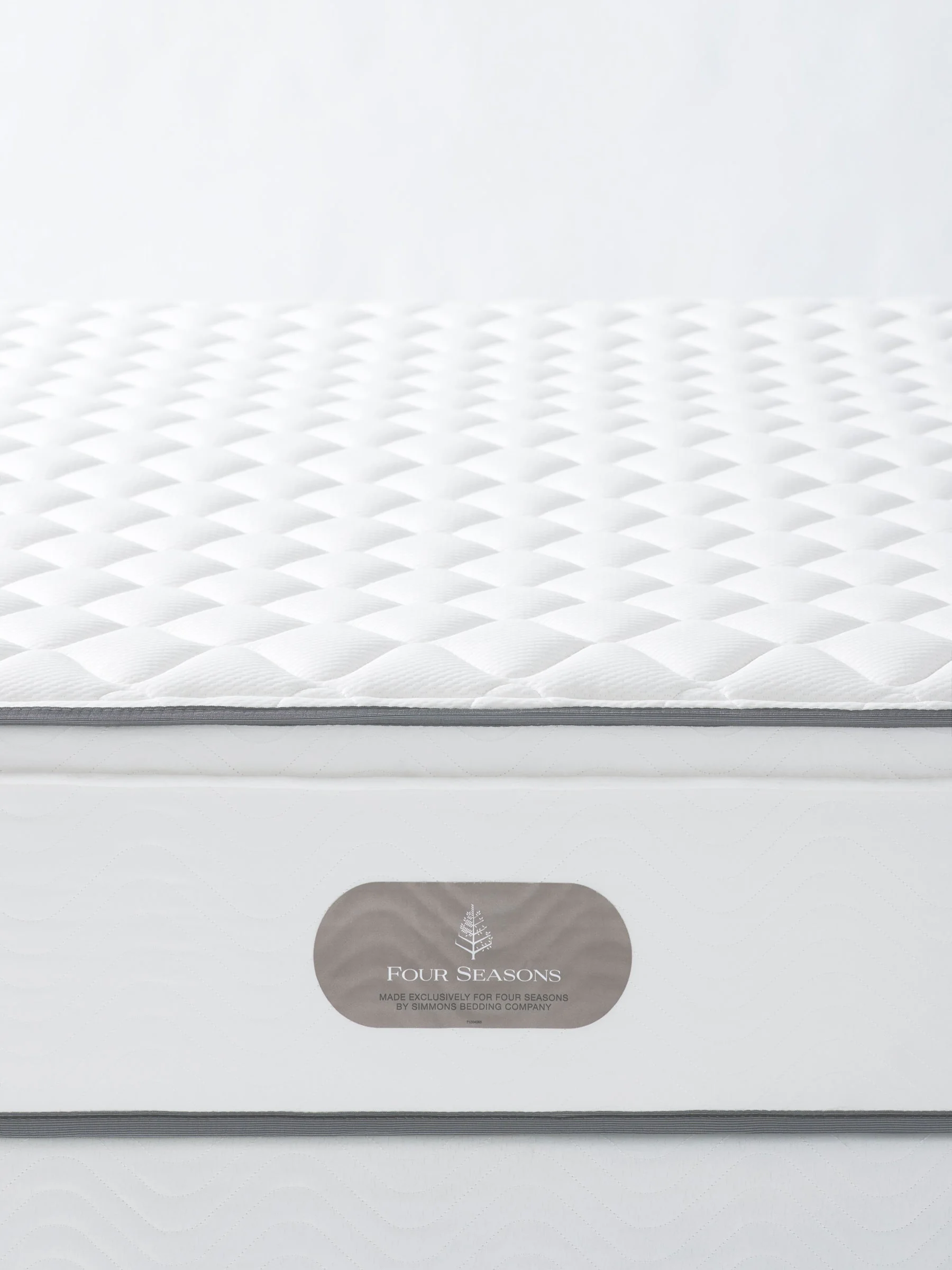 Close-up of the Four Seasons Signature Mattress highlighting its premium quilted surface for a luxury hotel bedroom experience.