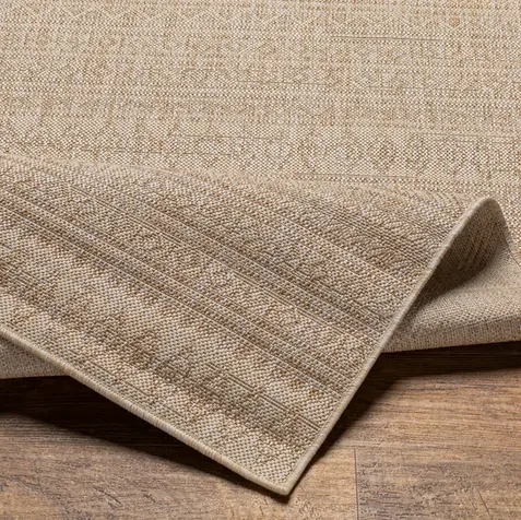 Beige woven indoor outdoor area rug with textured geometric patterns for quiet luxury, coastal, organic modern, and modern farmhouse interiors.