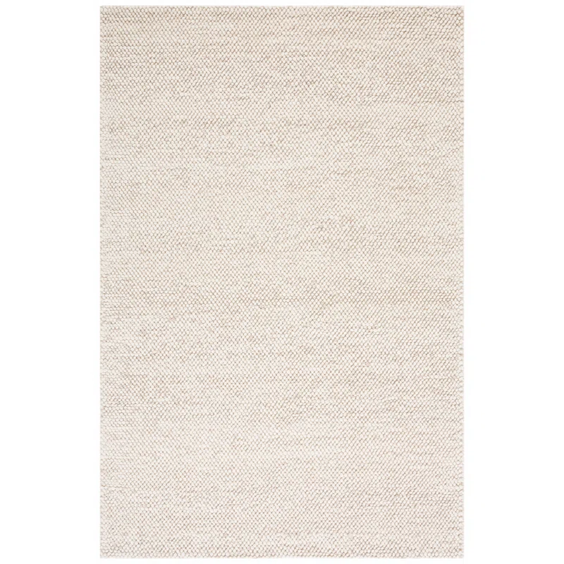 close up of textured wool rug with small bubble pattern in beige tones