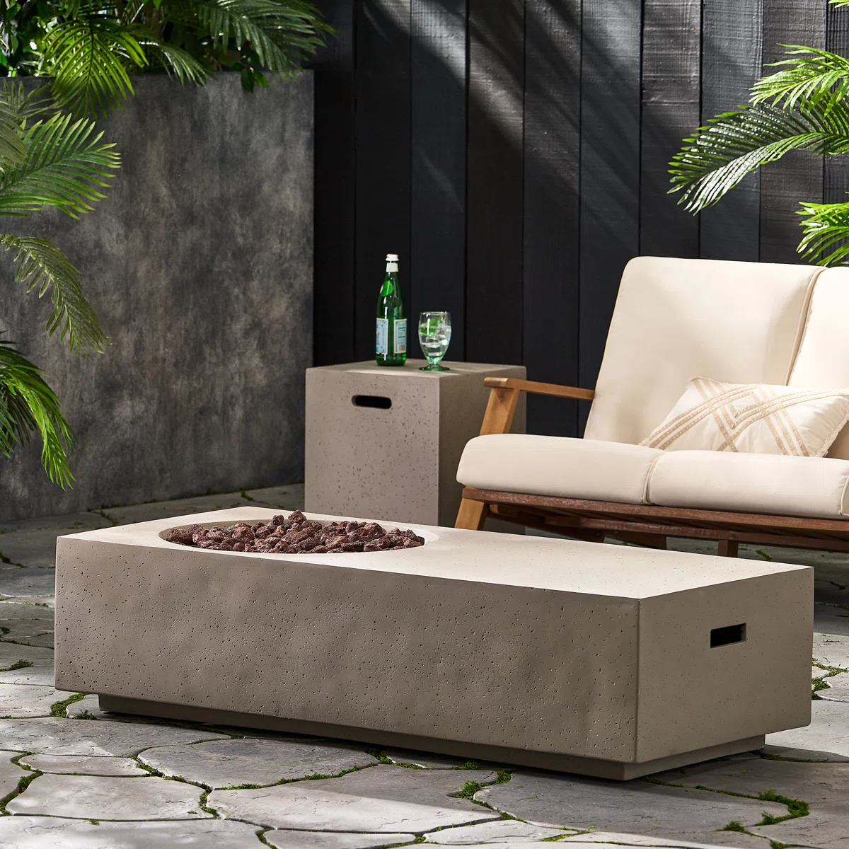modern outdoor sofa with neutral throw pillows high end patio and firepit