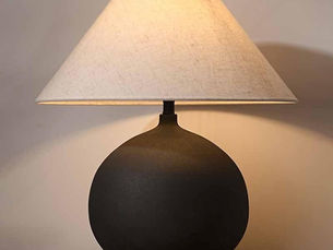 Sandyha table lamp with neutral ceramic base and linen shade on a modern side table