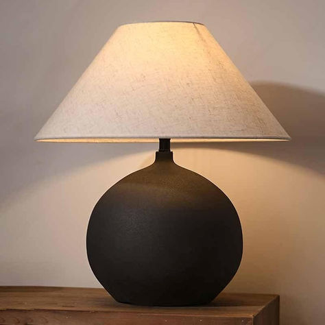 Sandyha table lamp with neutral ceramic base and linen shade on a modern side table