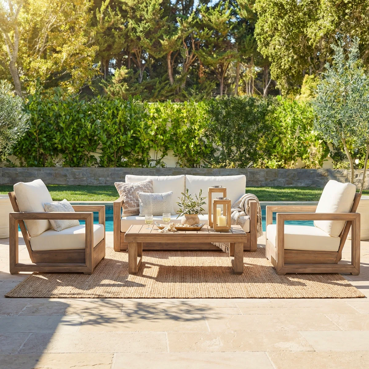 luxury outdoor patio seating with neutral cushions and greenery
