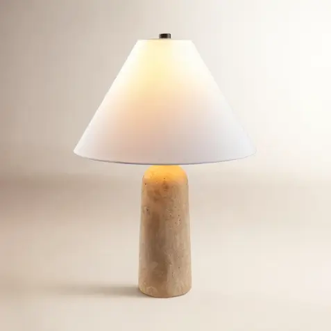 Natural travertine table lamp with a white linen shade for warm ambient lighting, perfect for quiet luxury, organic modern, and minimalist home decor.