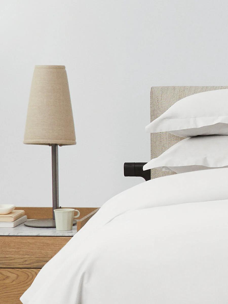 Luxury hotel bedroom styled with the Four Seasons Signature Hotel Duvet Cover Set, layered white bedding, and sophisticated bedside décor.