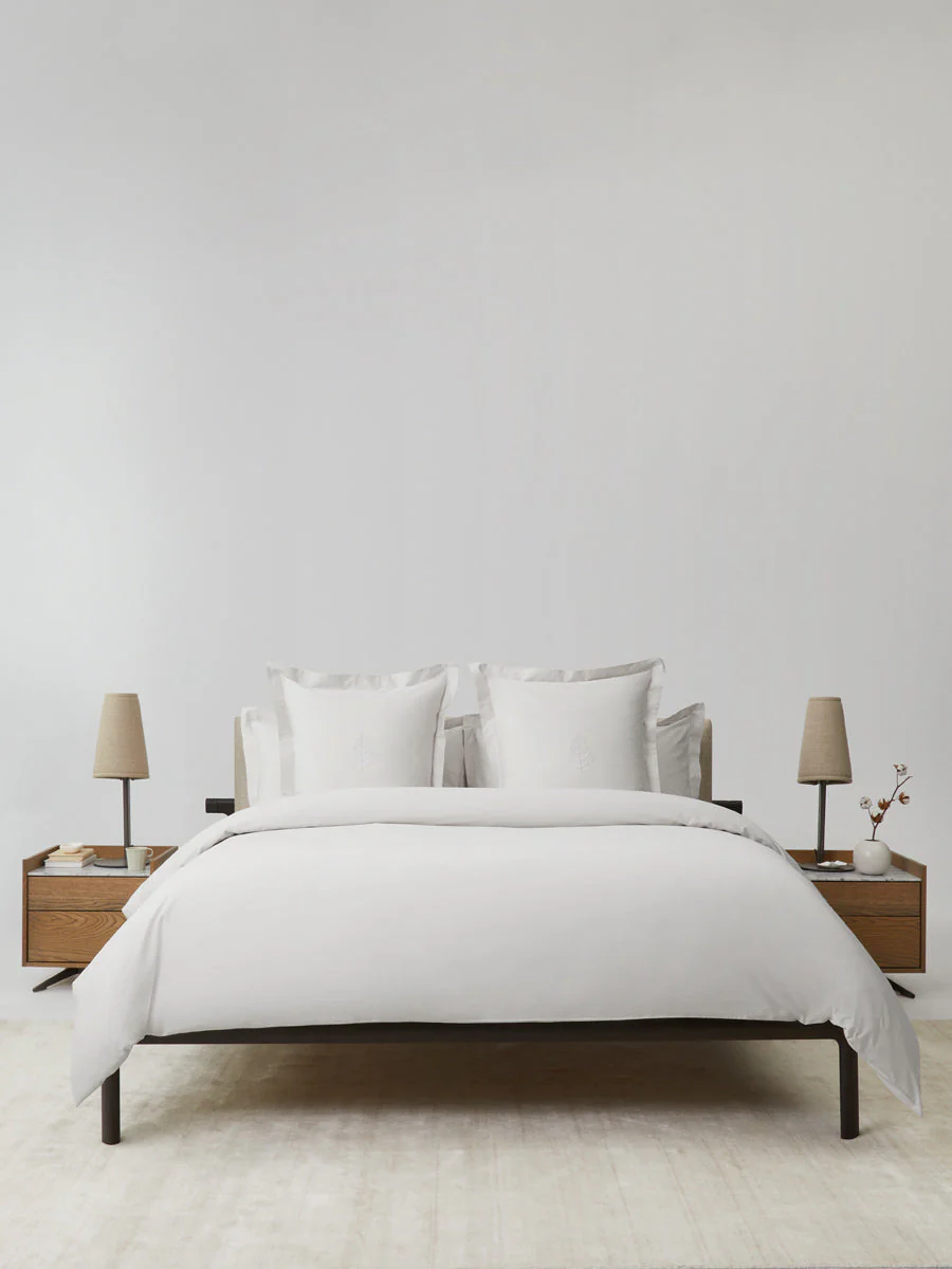 Luxury hotel bedroom featuring the Four Seasons Signature Hotel Linen Set with crisp white bedding and elegant minimalist décor.