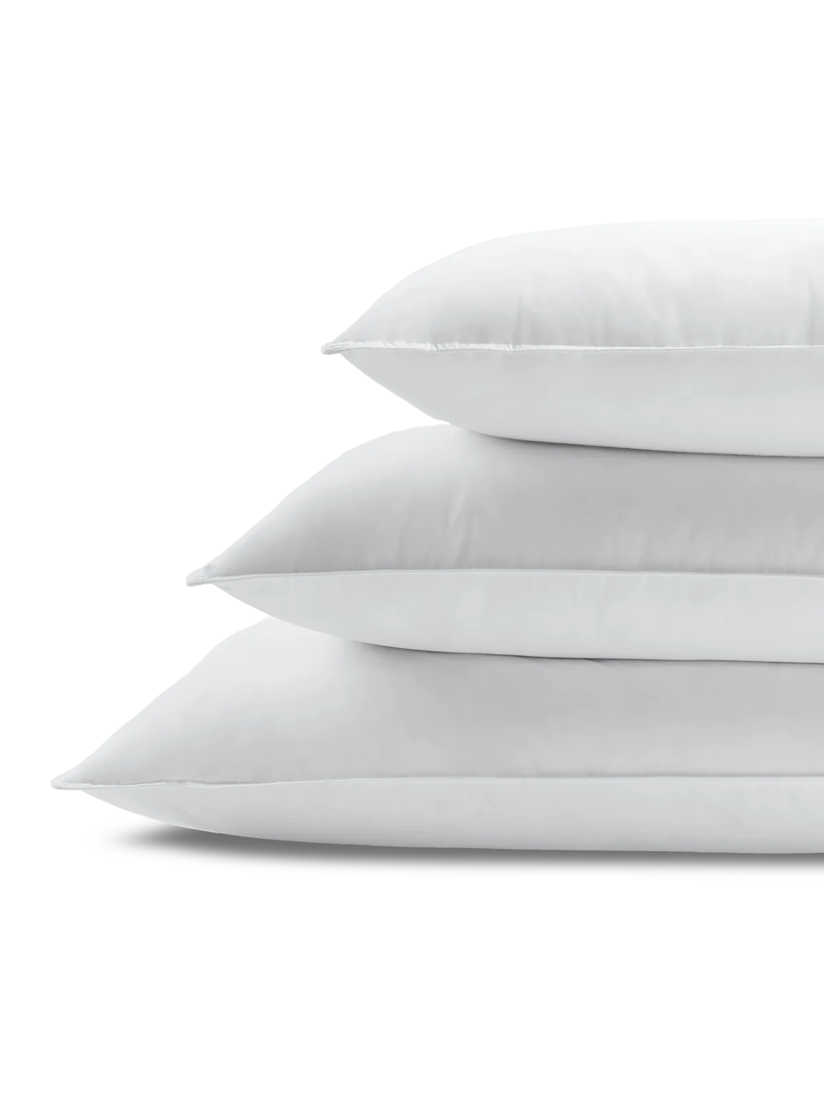 Stack of Four Seasons Signature Feather and Down Pillows designed to deliver exceptional comfort in a luxury hotel bedroom.