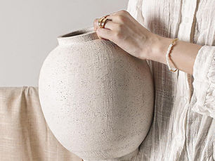 Neutral ceramic decorative vase for modern home decor styling in a living room.