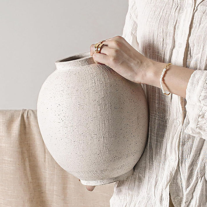 Large white ceramic vase in a minimalist neutral home decor setting