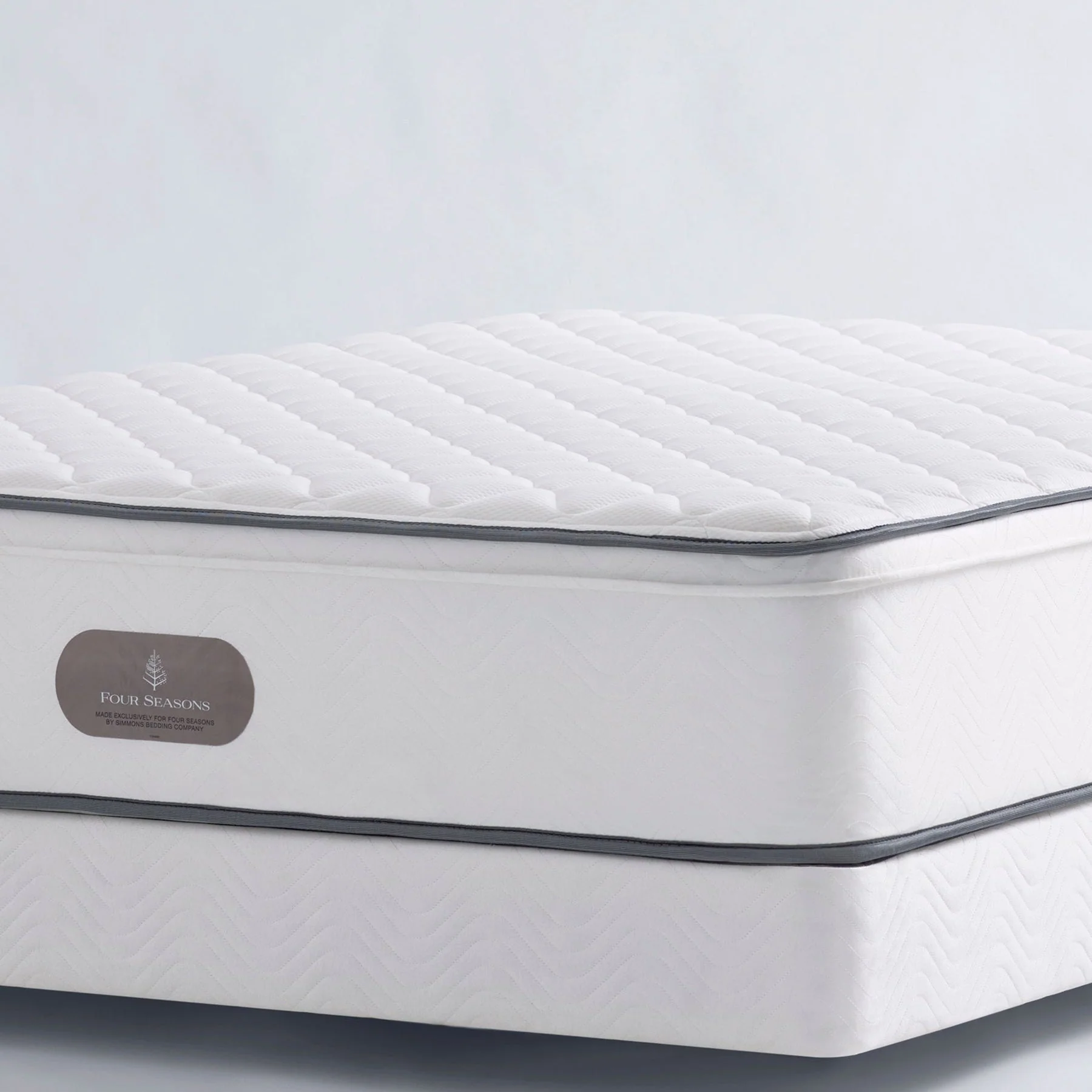 Luxury hotel bedroom mattress by Four Seasons featuring premium craftsmanship, plush comfort, and elegant white upholstery.
